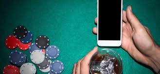 Filipino player checking the 888ph Wins feed on a smartphone before choosing a slot game